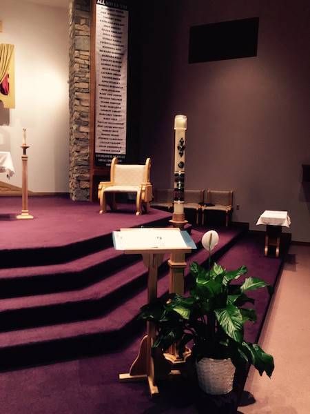 church altar dimly lit with the book of remembrance