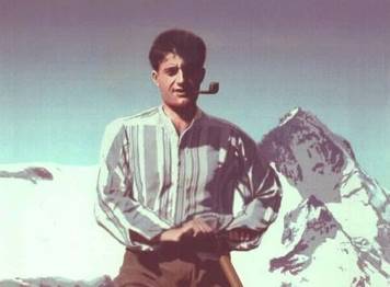 Blessed Pier Giorgio Frasatti with a pipe in front of a mountain photo taken from his website