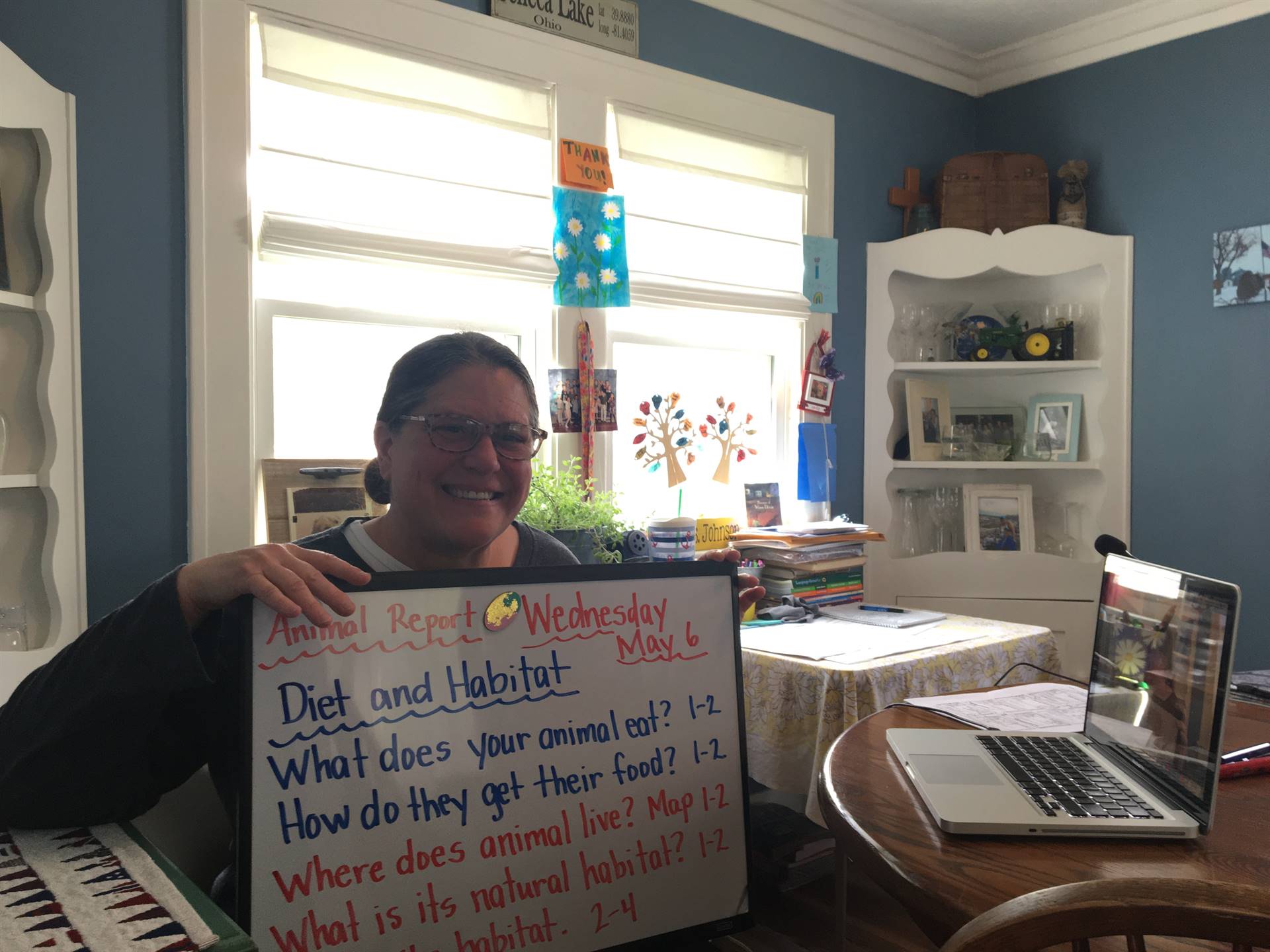 mrs. johnson poses with her whiteboard