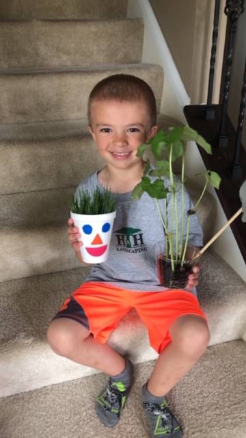 boy showing his plants