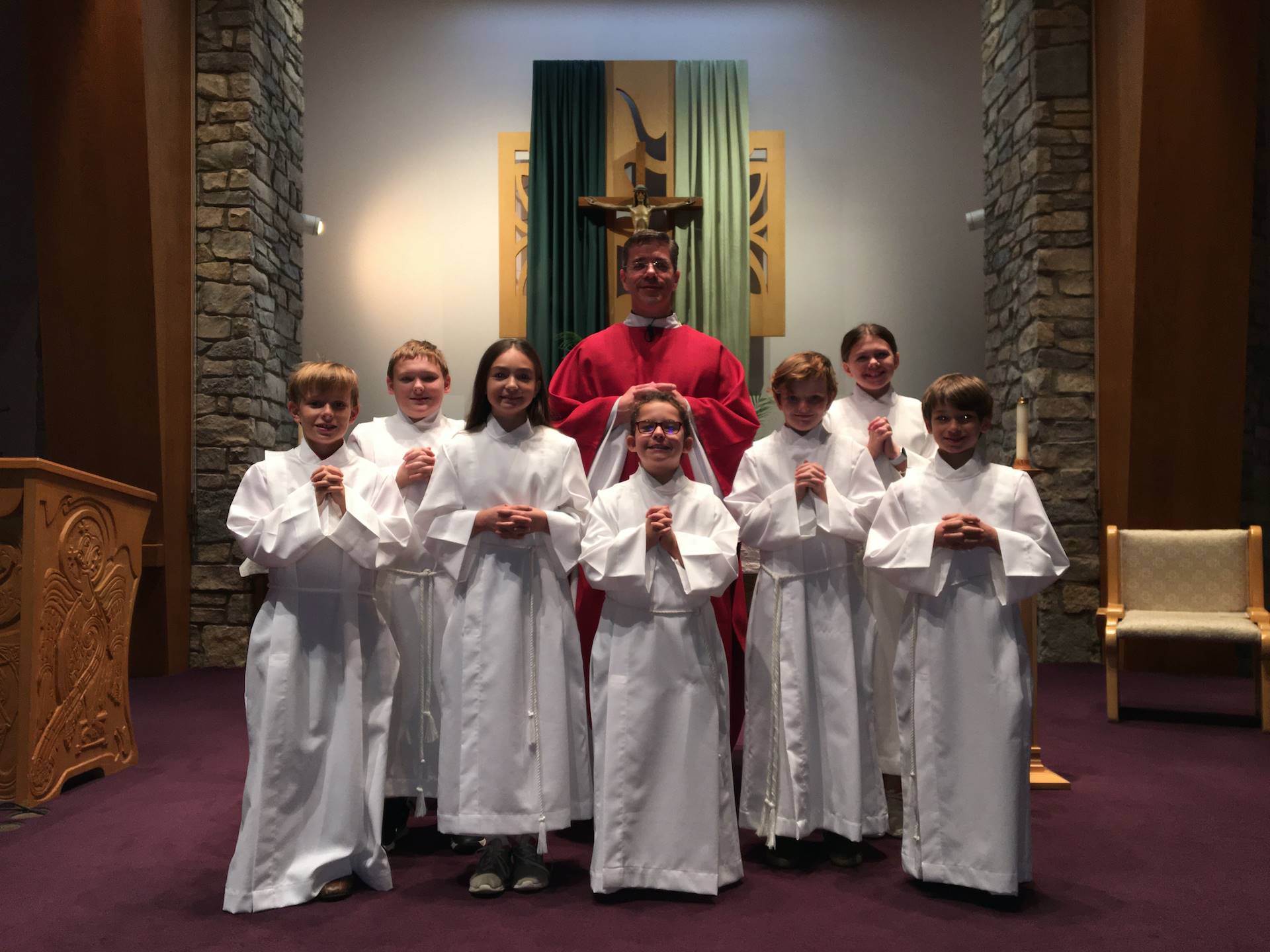 Fr. Tom and the newly trained altar servers pose for a picture