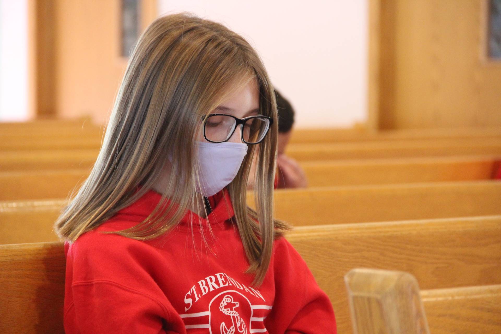 girls sits in meditation during adoration