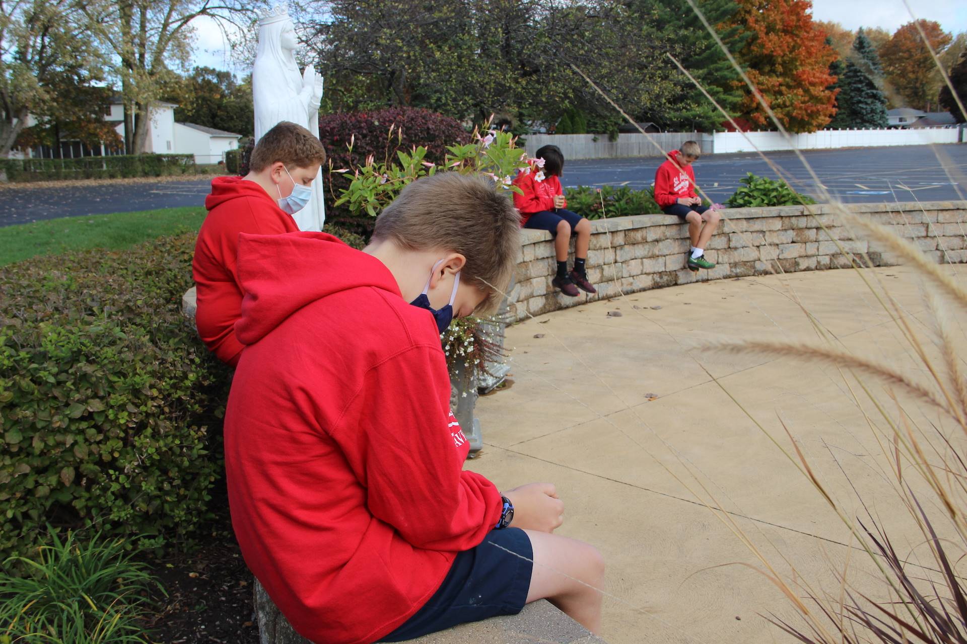 students pray in the our lady of knock prayer garden