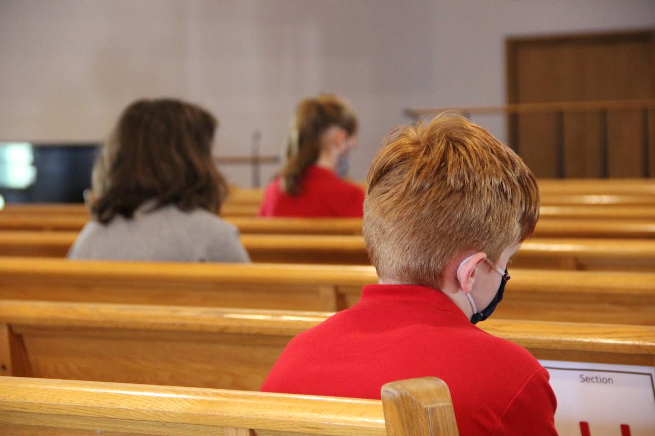 students pray in church