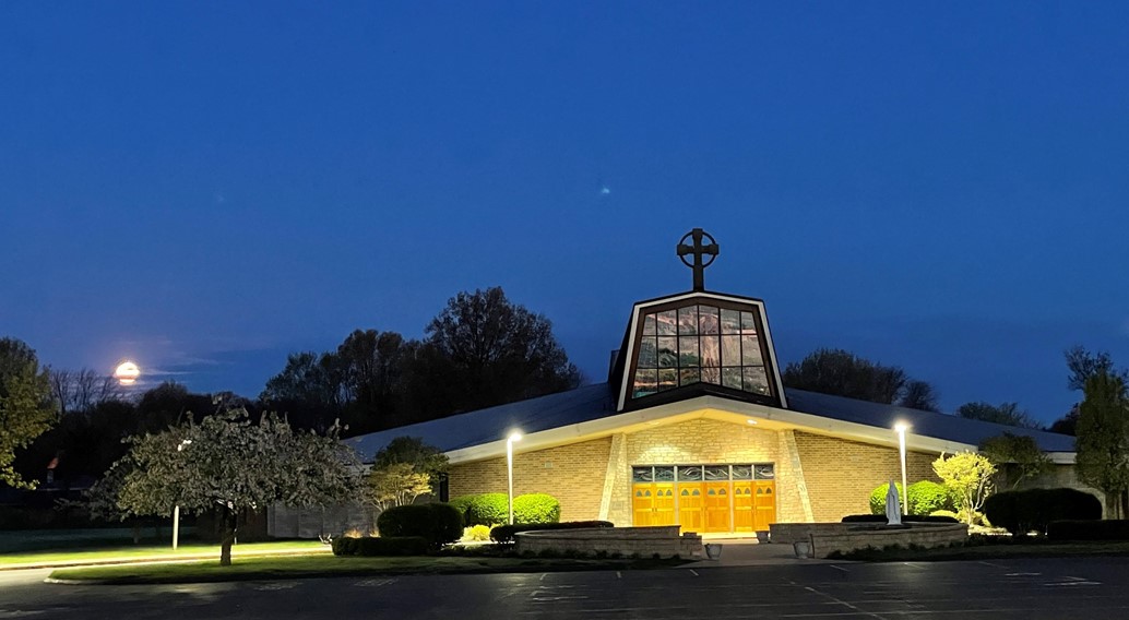 church during dawn with a full moon