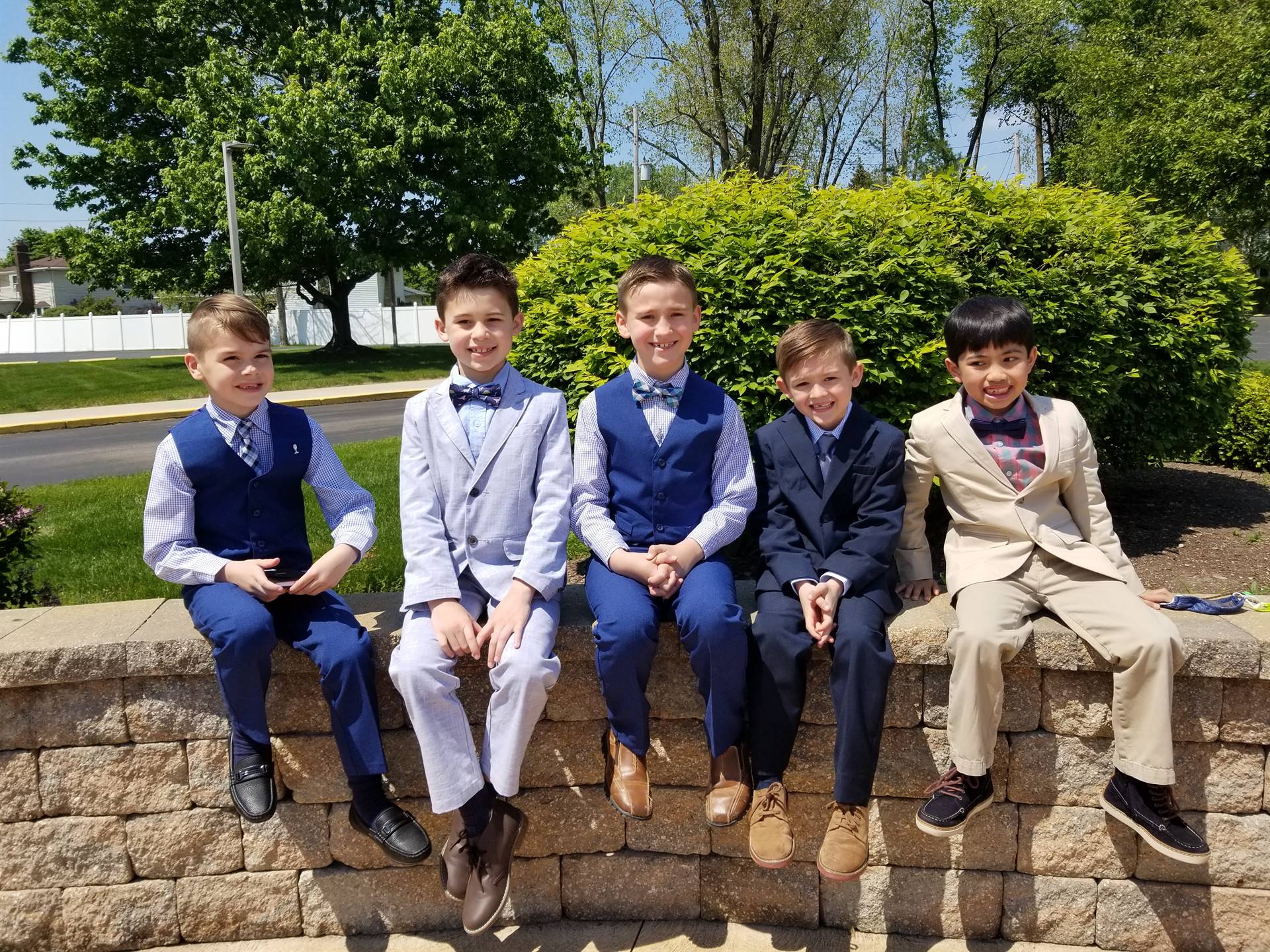 boys in suits smile after their first communion