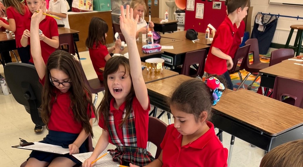 eager students raise hands to respond