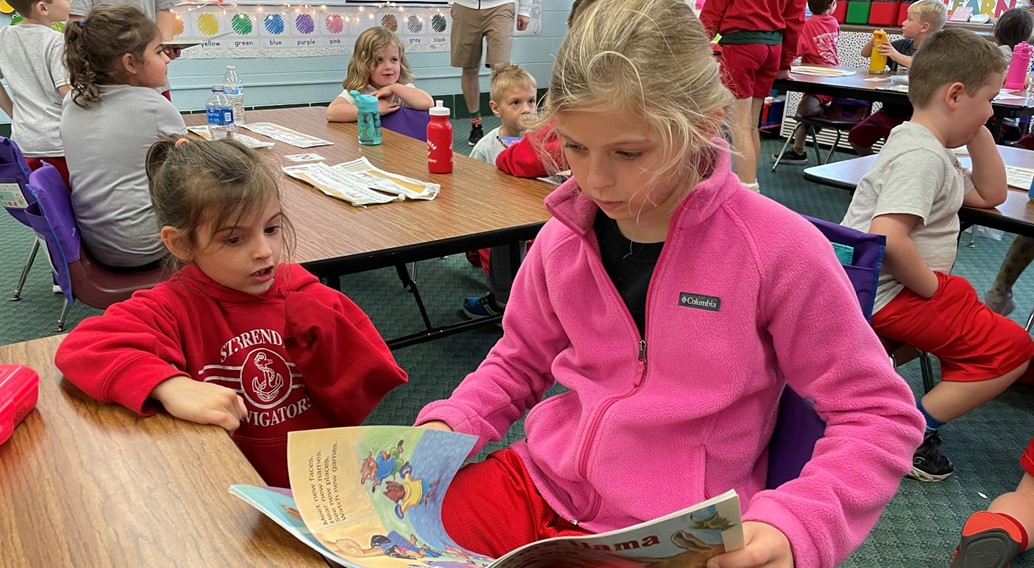 grade 5 buddies with kinder for story time