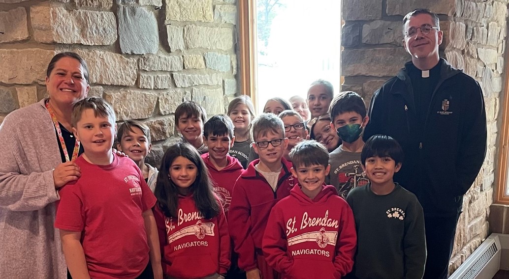 4th grade learns about the saints windows in the church from fr tom