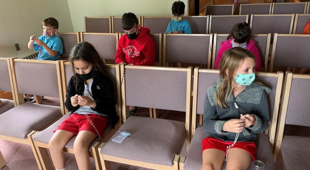 catholic kids club prays a rosary