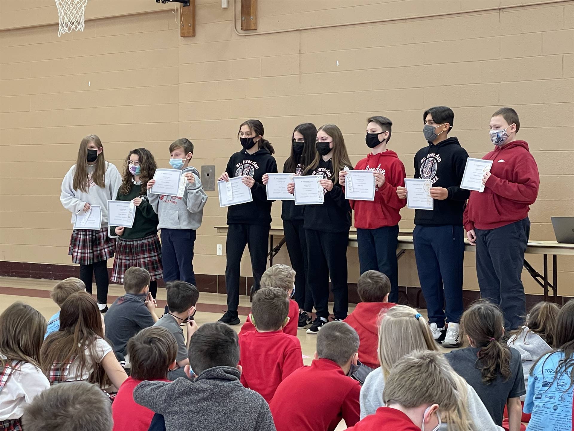 students showing award certificates