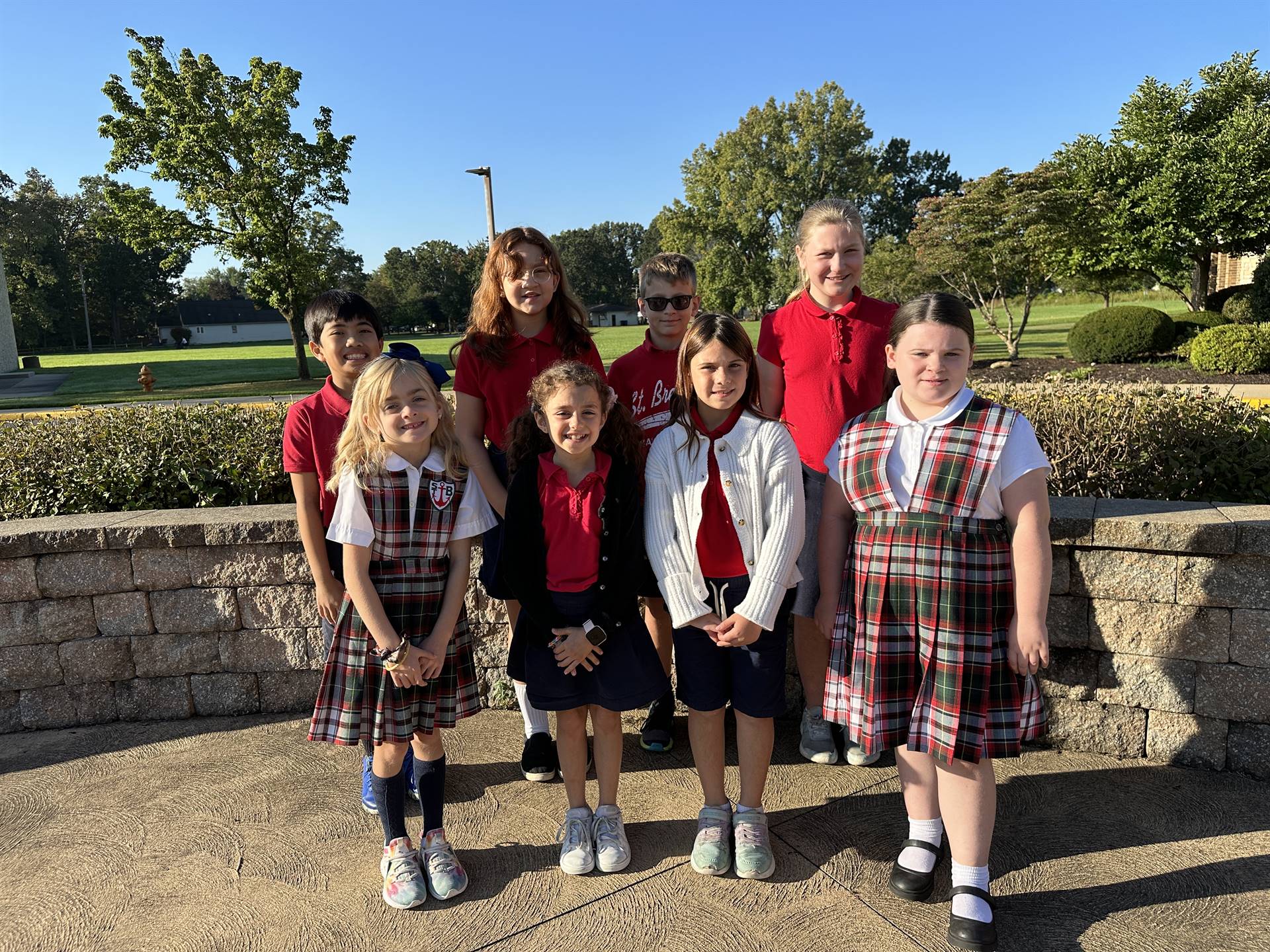 students pose in prayer garden