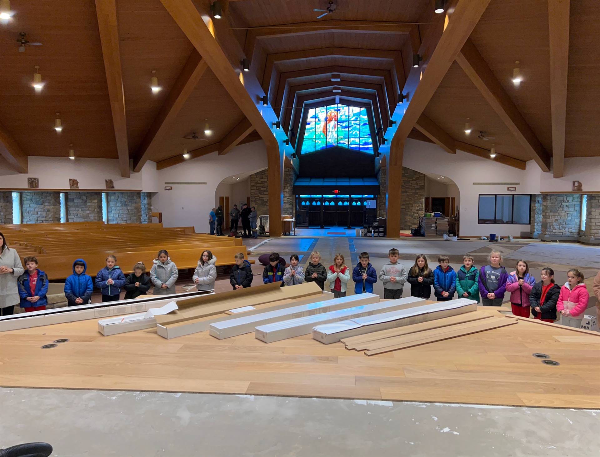 *school children sign the sanctuary steps writing "Jesus"
