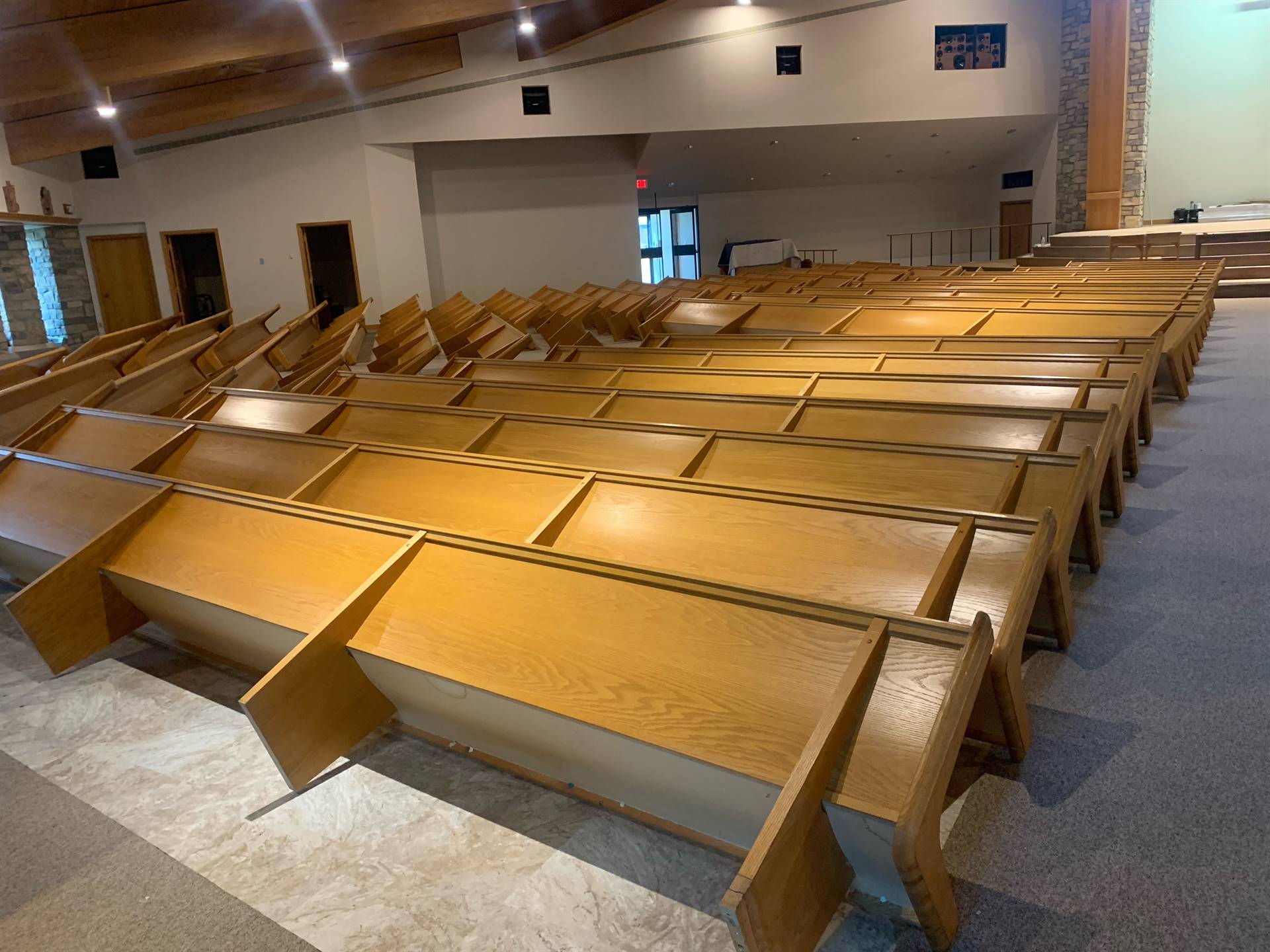 pews being stained and reinstalled