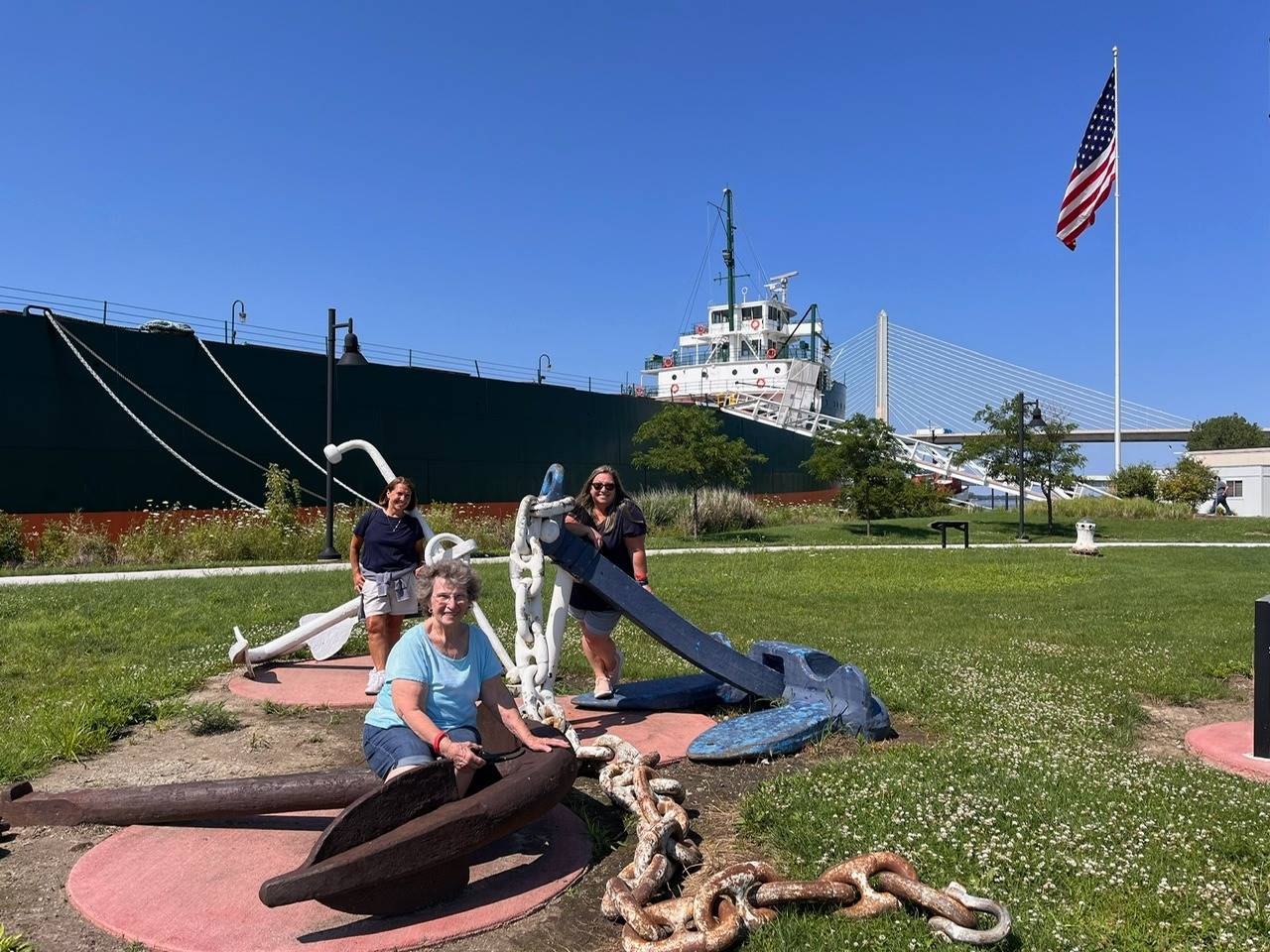 3 teachers pose by anchor at the great lakes museum in toledo