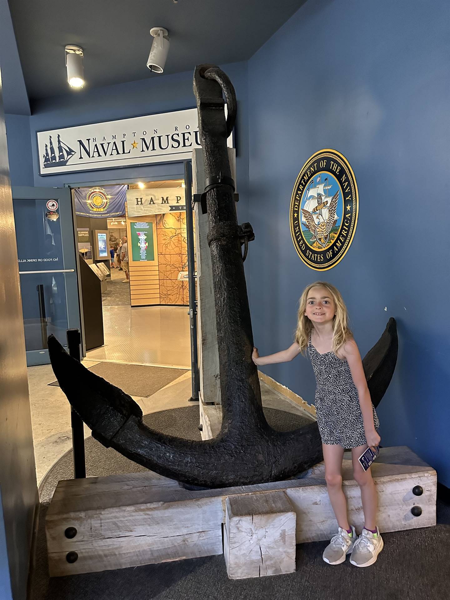 student poses by and anchor on summer break