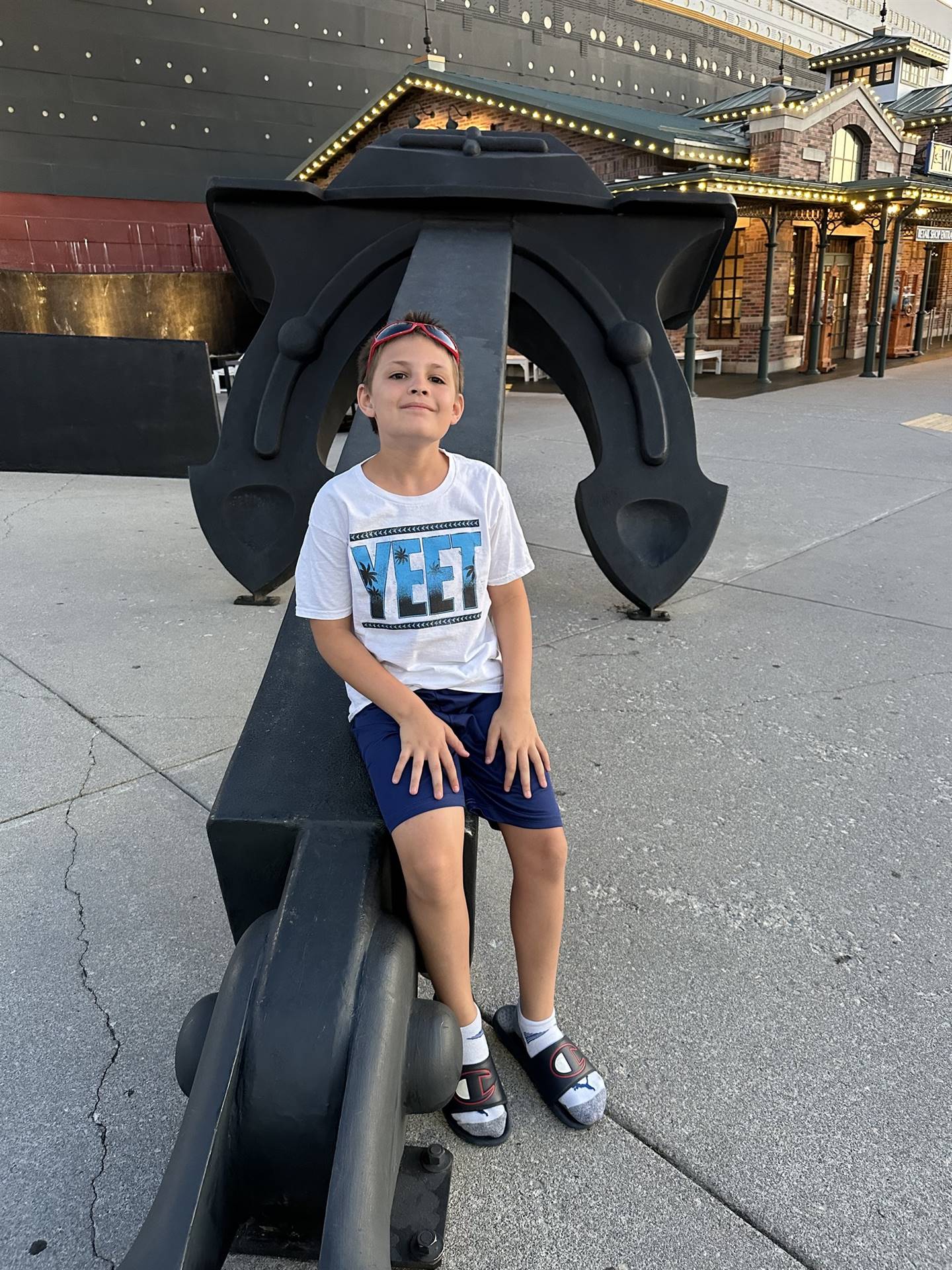 student poses by and anchor on summer break
