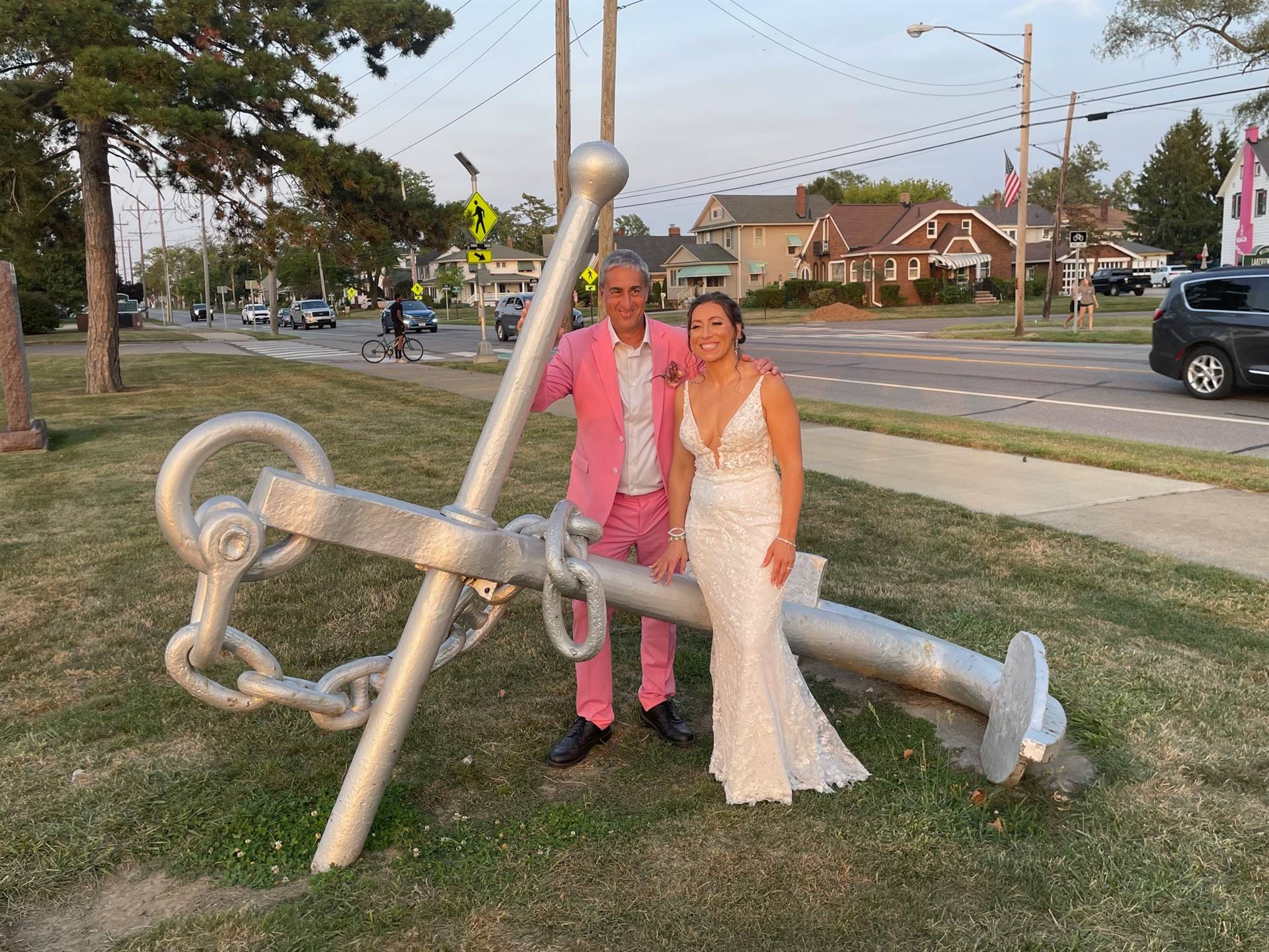 a staff member and his daughter pose by an anchor on her wedding day!
