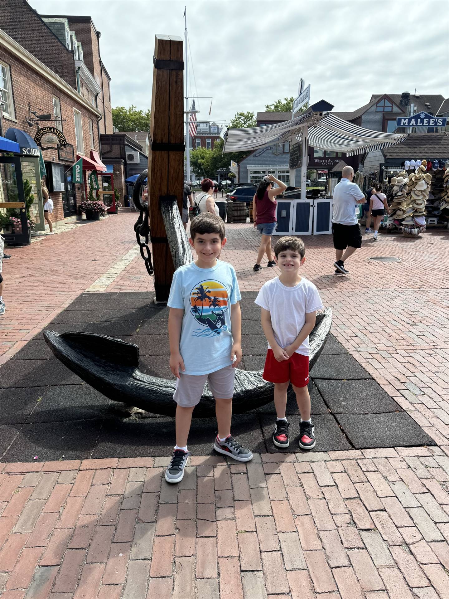 students pose by and anchor on summer break