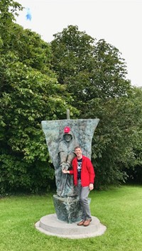 Fr. Tom Woost in Ireland with fountain Statue of St. Brendan